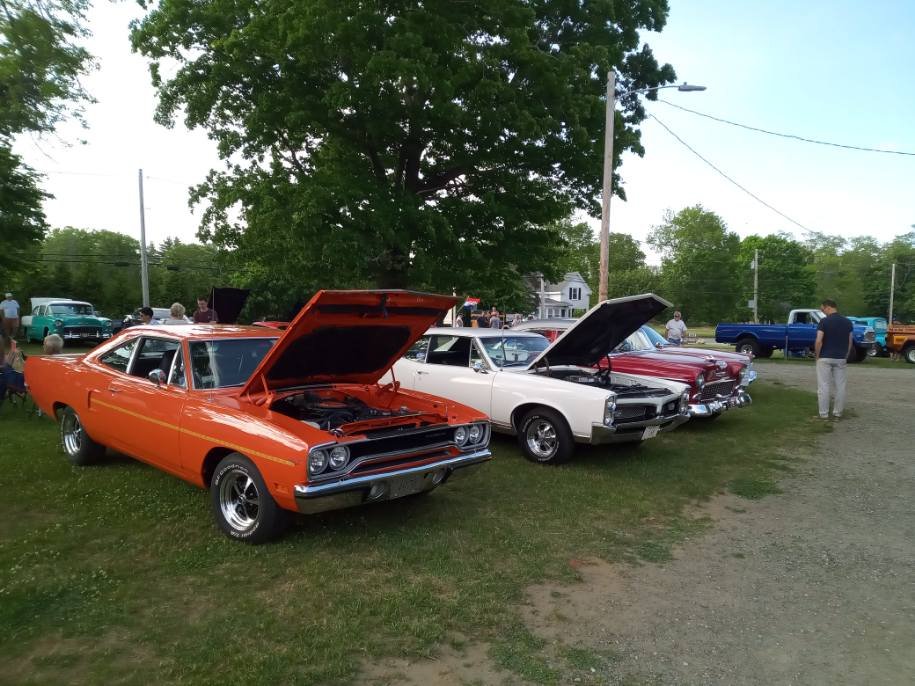 Orange muscle car, white classic, and red coupe with hoods up