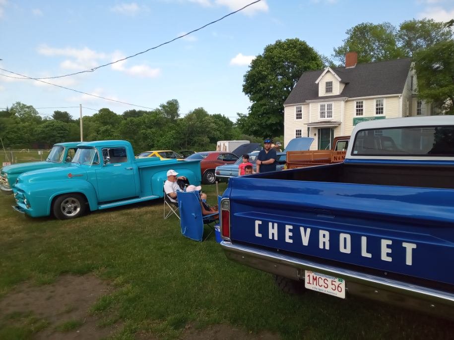 Turquoise Ford and Chevrolet pickup trucks parked side by side