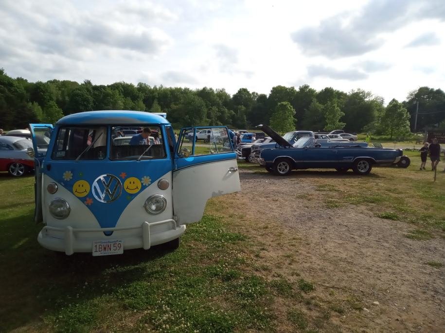 Vintage blue and white VW bus with flower decals